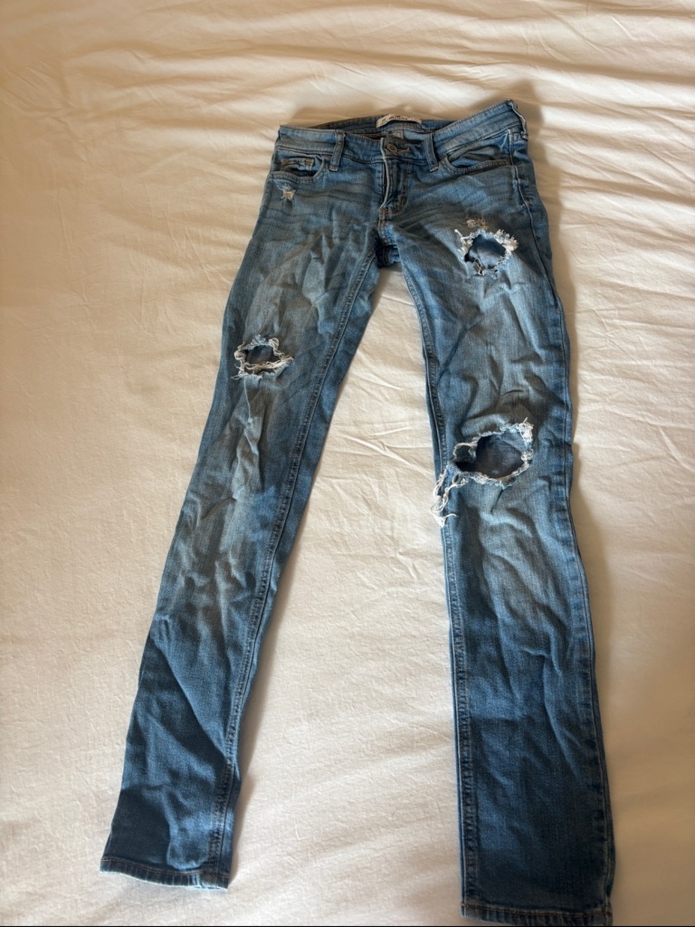 Hollister Women's Ripped Skinny Jeans in Faded Blue